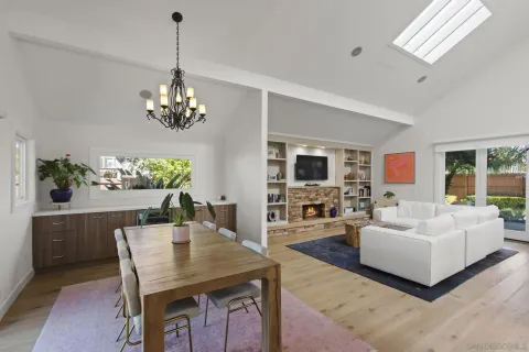 a view of a dining room with furniture a livingroom and chandelier