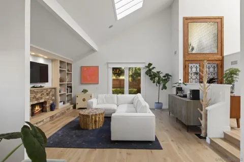a living room with fireplace furniture and a flat screen tv