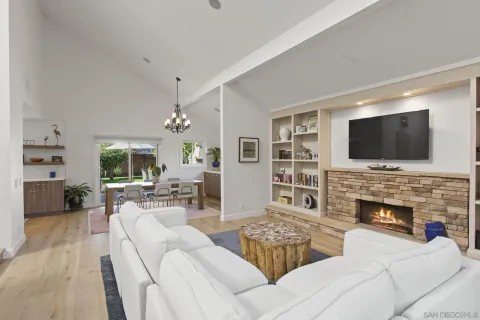 a living room with fireplace furniture and a flat screen tv