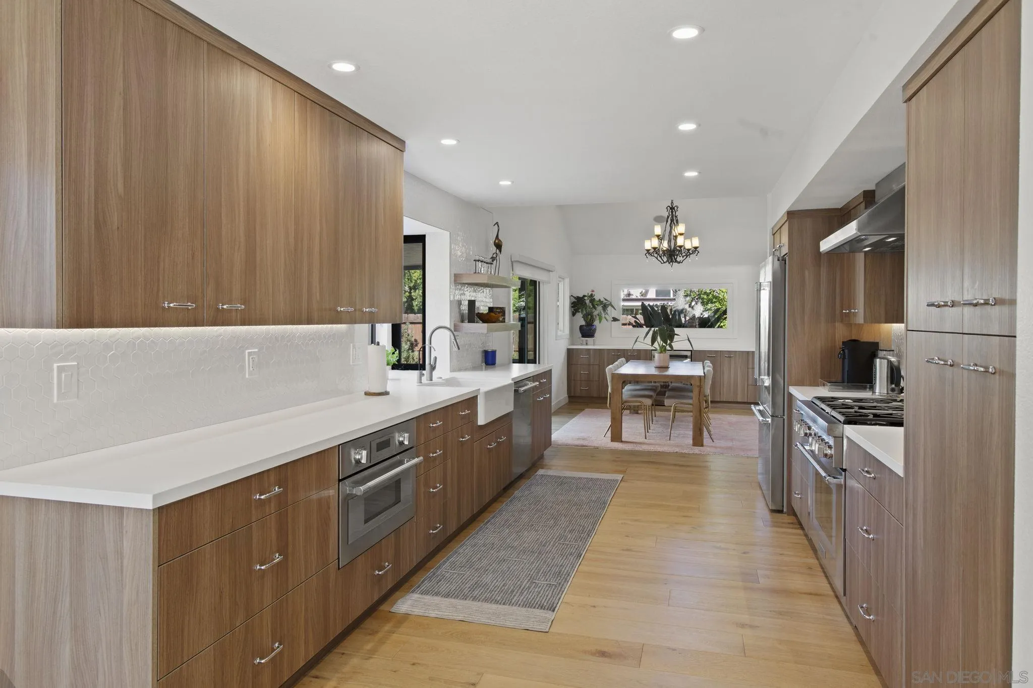 3942 Avenida Brisa Rancho Santa Fe, CA 92091 - Photo 17 of 47 a large kitchen with stainless steel appliances a large counter top a stove and a refrigerator