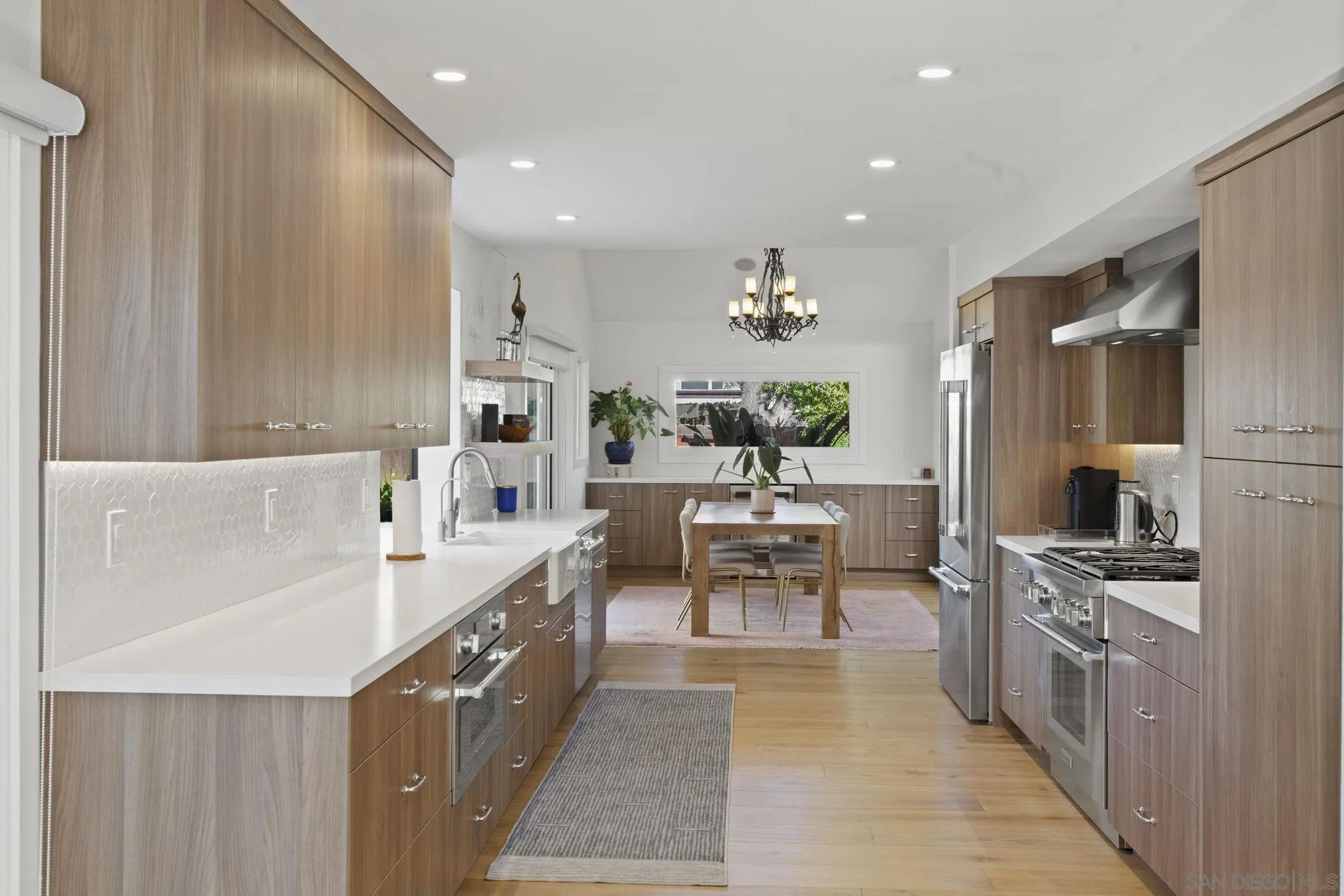 3942 Avenida Brisa Rancho Santa Fe, CA 92091 - Photo 18 of 47 a kitchen with stainless steel appliances kitchen island granite countertop a sink and cabinets