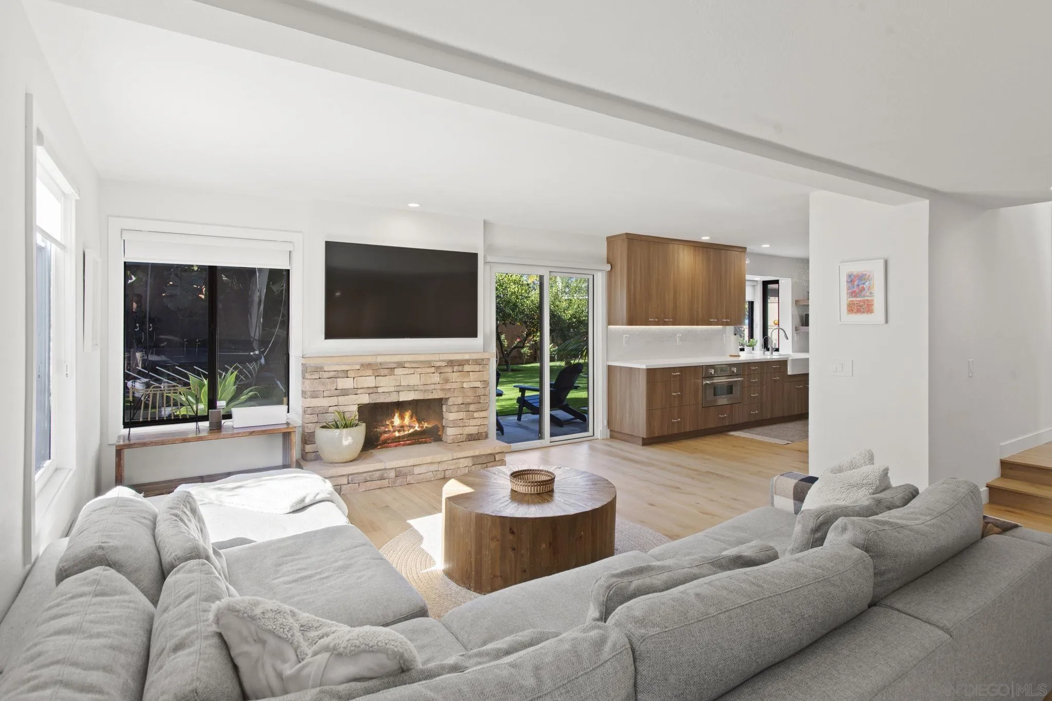 3942 Avenida Brisa Rancho Santa Fe, CA 92091 - Photo 20 of 47 a living room with furniture a fireplace and a flat screen tv