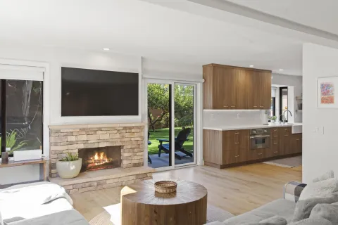 a living room with furniture a fireplace and a flat screen tv