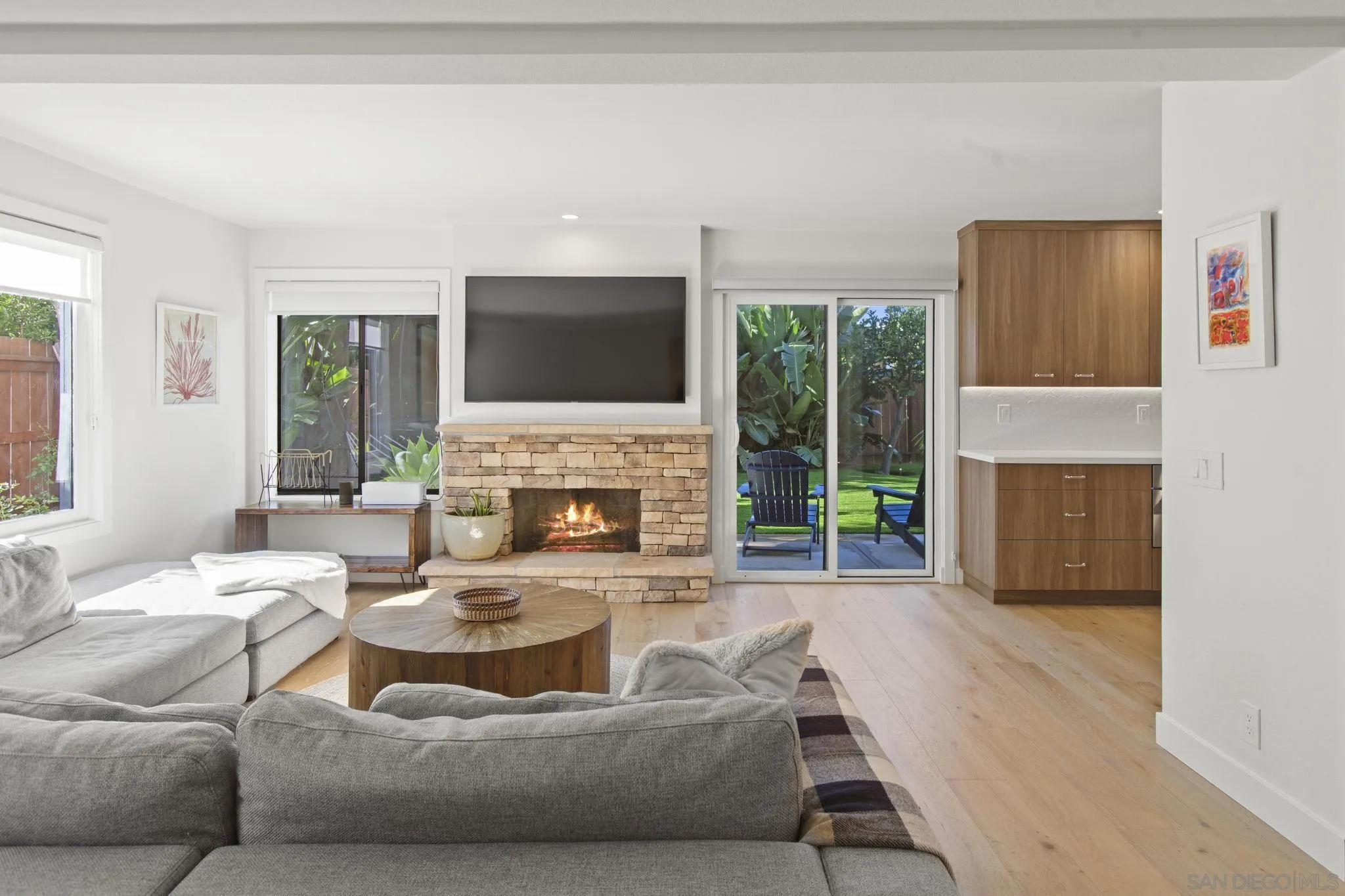 3942 Avenida Brisa Rancho Santa Fe, CA 92091 - Photo 23 of 47 a living room with furniture a fireplace and a flat screen tv