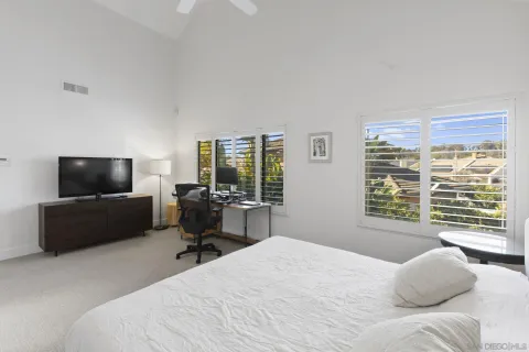 a bedroom with a bed and a television