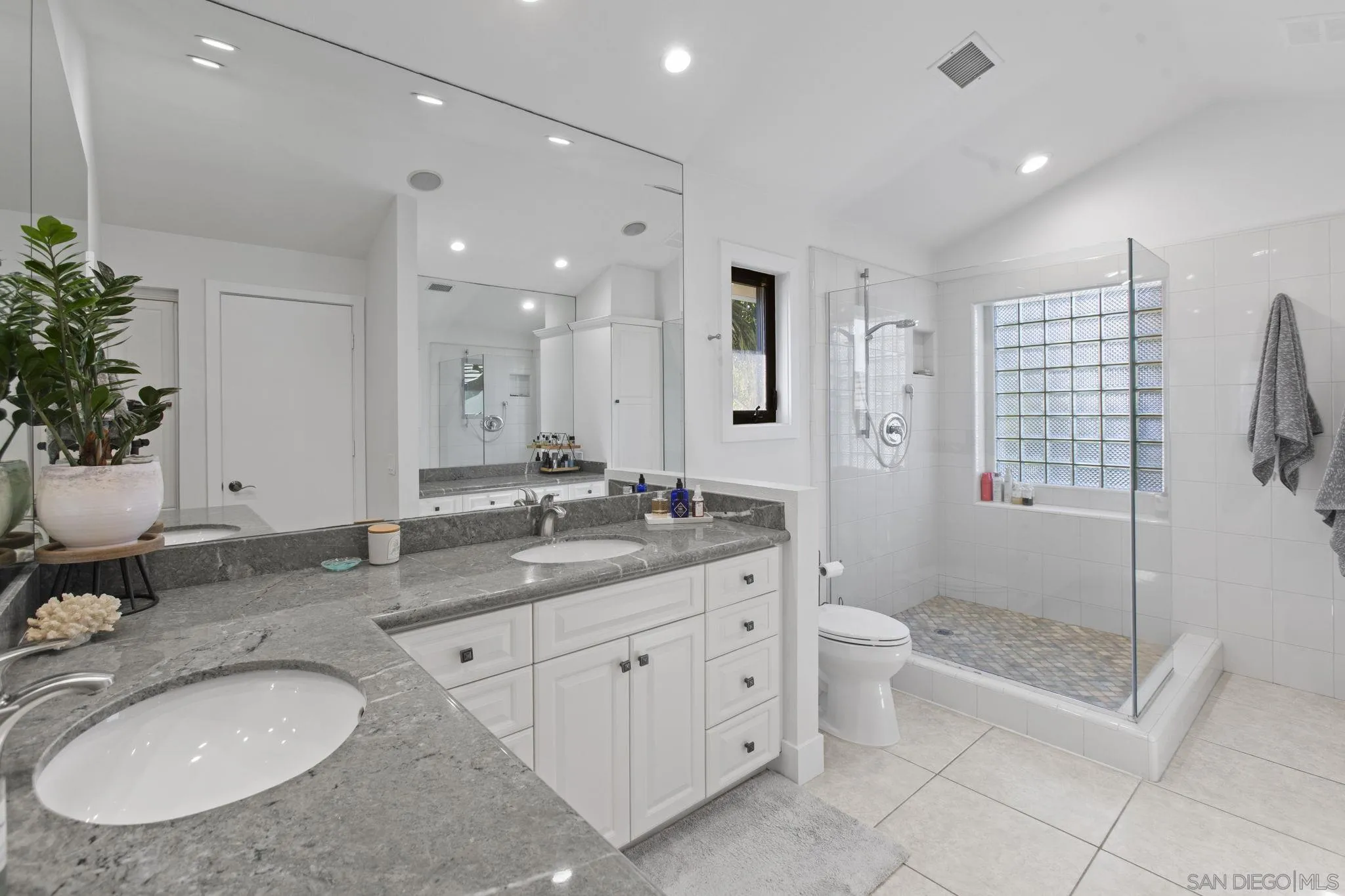 3942 Avenida Brisa Rancho Santa Fe, CA 92091 - Photo 29 of 47 a bathroom with a granite countertop sink mirror and shower