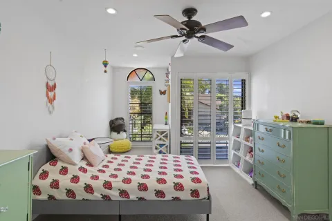 a bedroom with a bed a table and chair