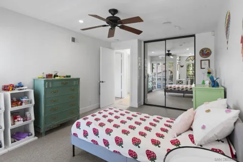a bedroom with a bed and cabinets