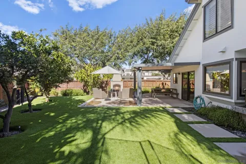 a view of a house with backyard porch and sitting area