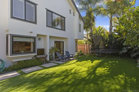 a view of a house with backyard porch and sitting area