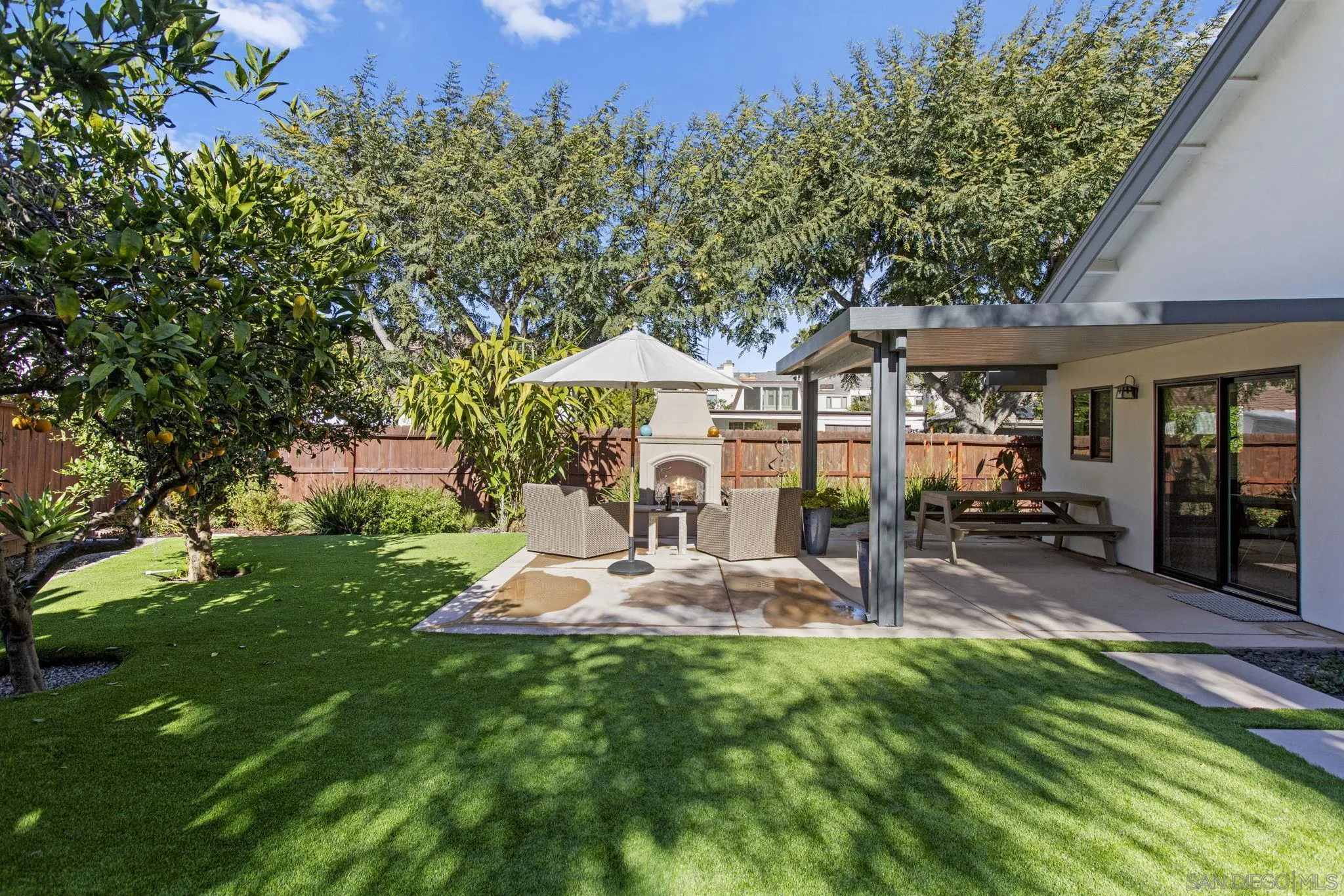 3942 Avenida Brisa Rancho Santa Fe, CA 92091 - Photo 8 of 47 a view of a patio with table and chairs under an umbrella