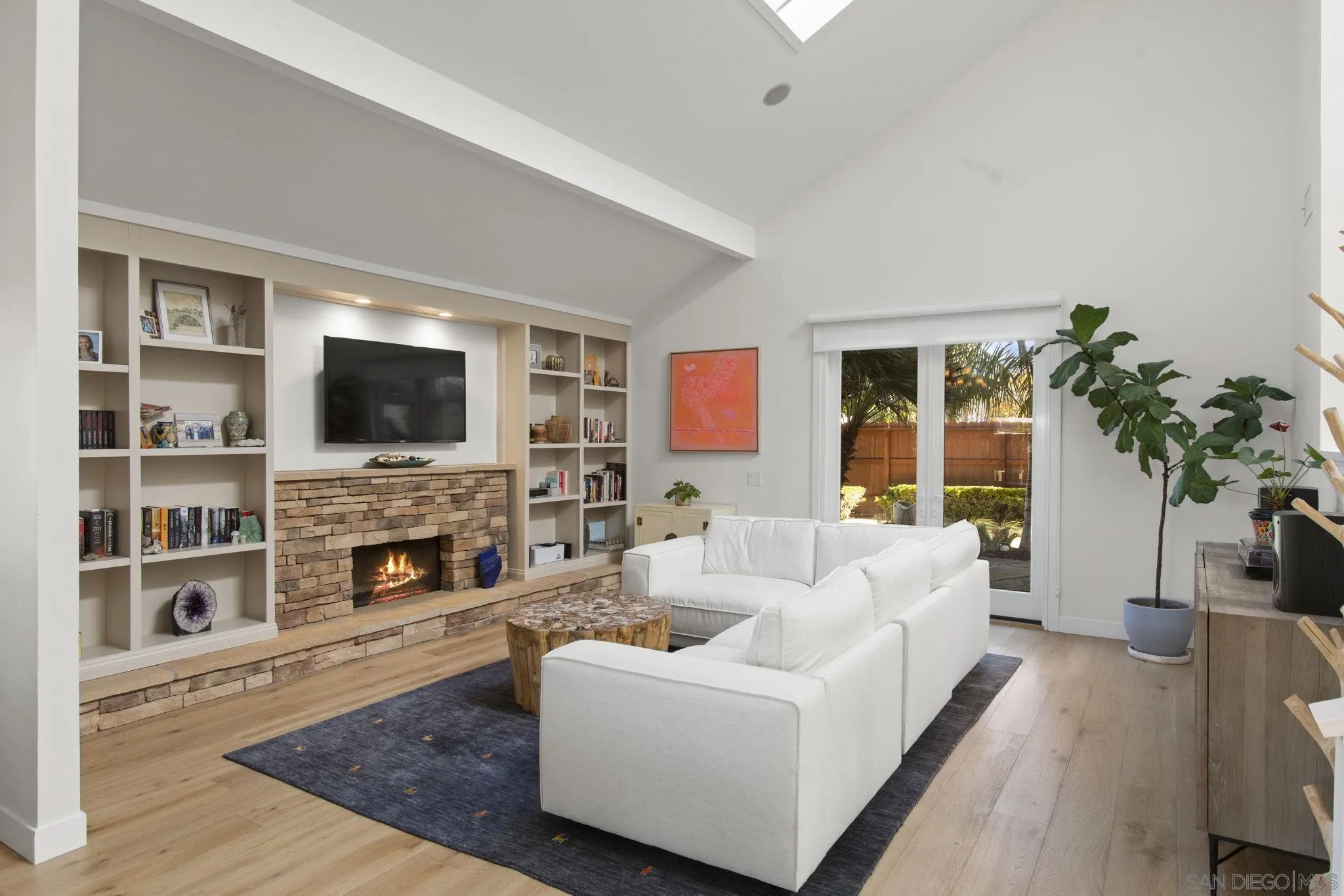 3942 Avenida Brisa Rancho Santa Fe, CA 92091 - Photo 10 of 47 a living room with fireplace furniture and a flat screen tv