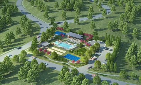 an aerial view of a residential houses with yard