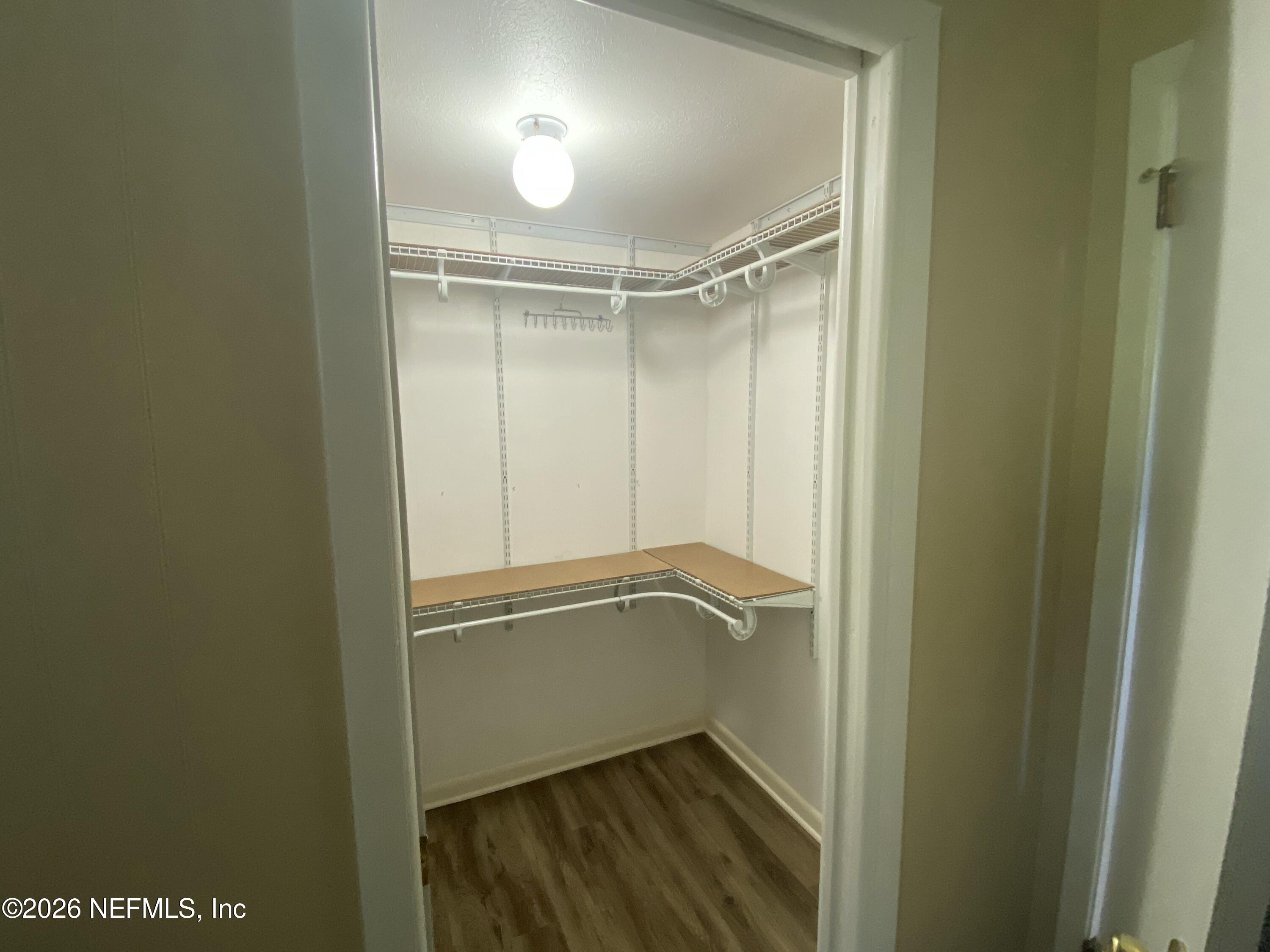104 St Elmo Road Green Cove Springs, FL 32043 - Photo 11 of 24 a bathroom with a glass door shower and hardwood floor