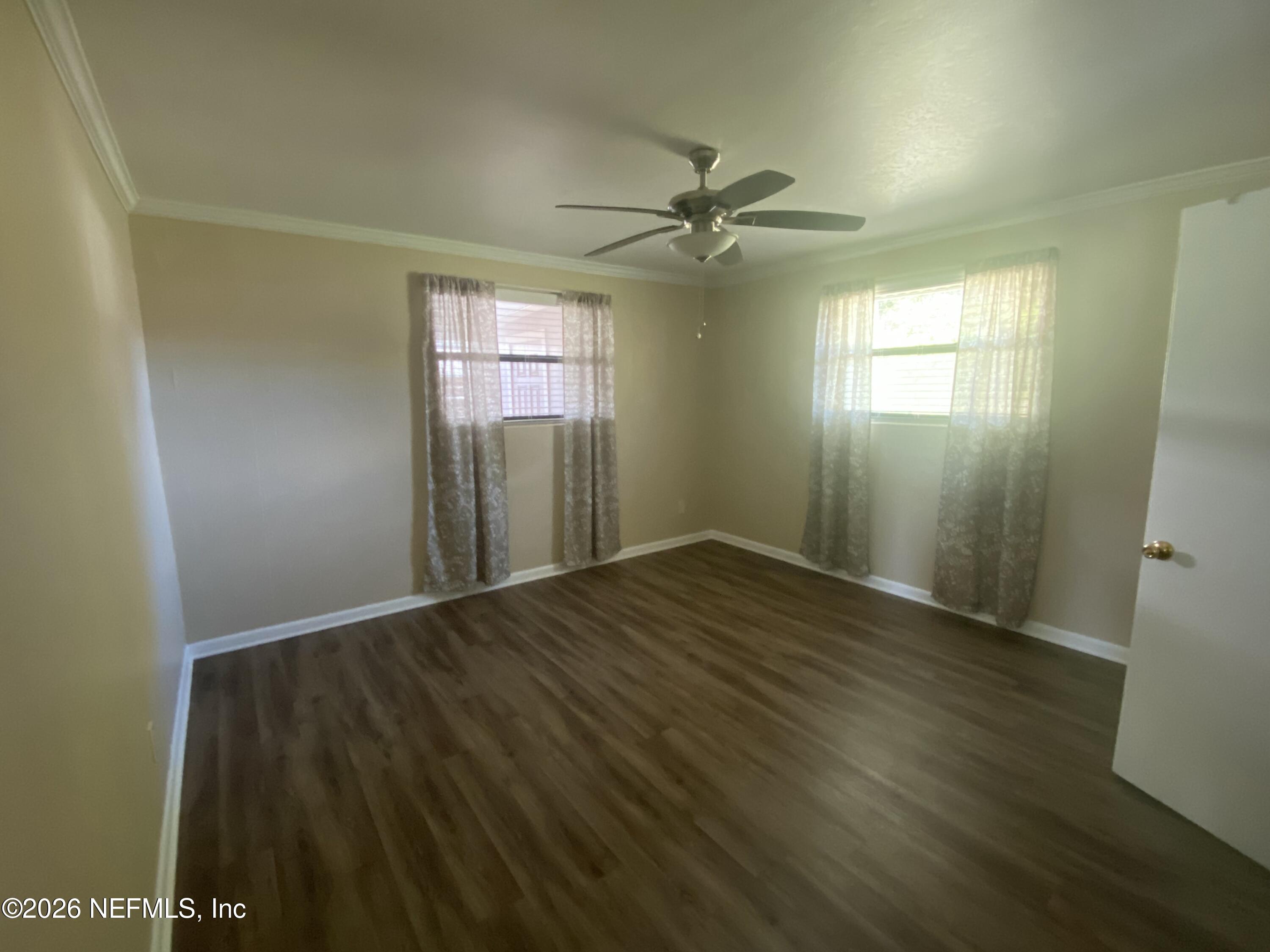 104 St Elmo Road Green Cove Springs, FL 32043 - Photo 12 of 24 a view of empty room with wooden floor and fan