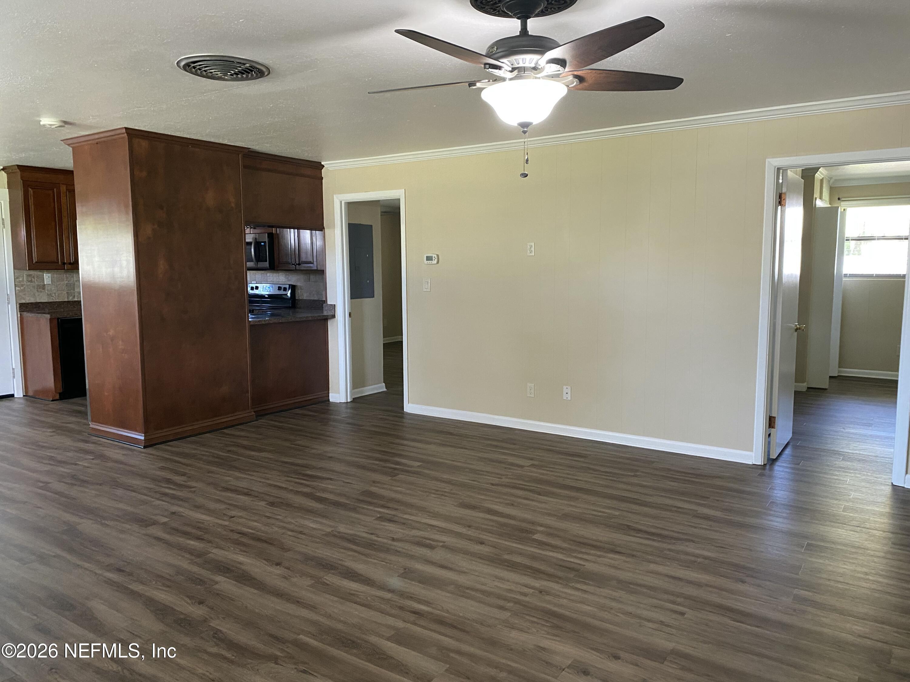 104 St Elmo Road Green Cove Springs, FL 32043 - Photo 18 of 24 a view of a livingroom with a ceiling fan wooden floor and a ceiling fan