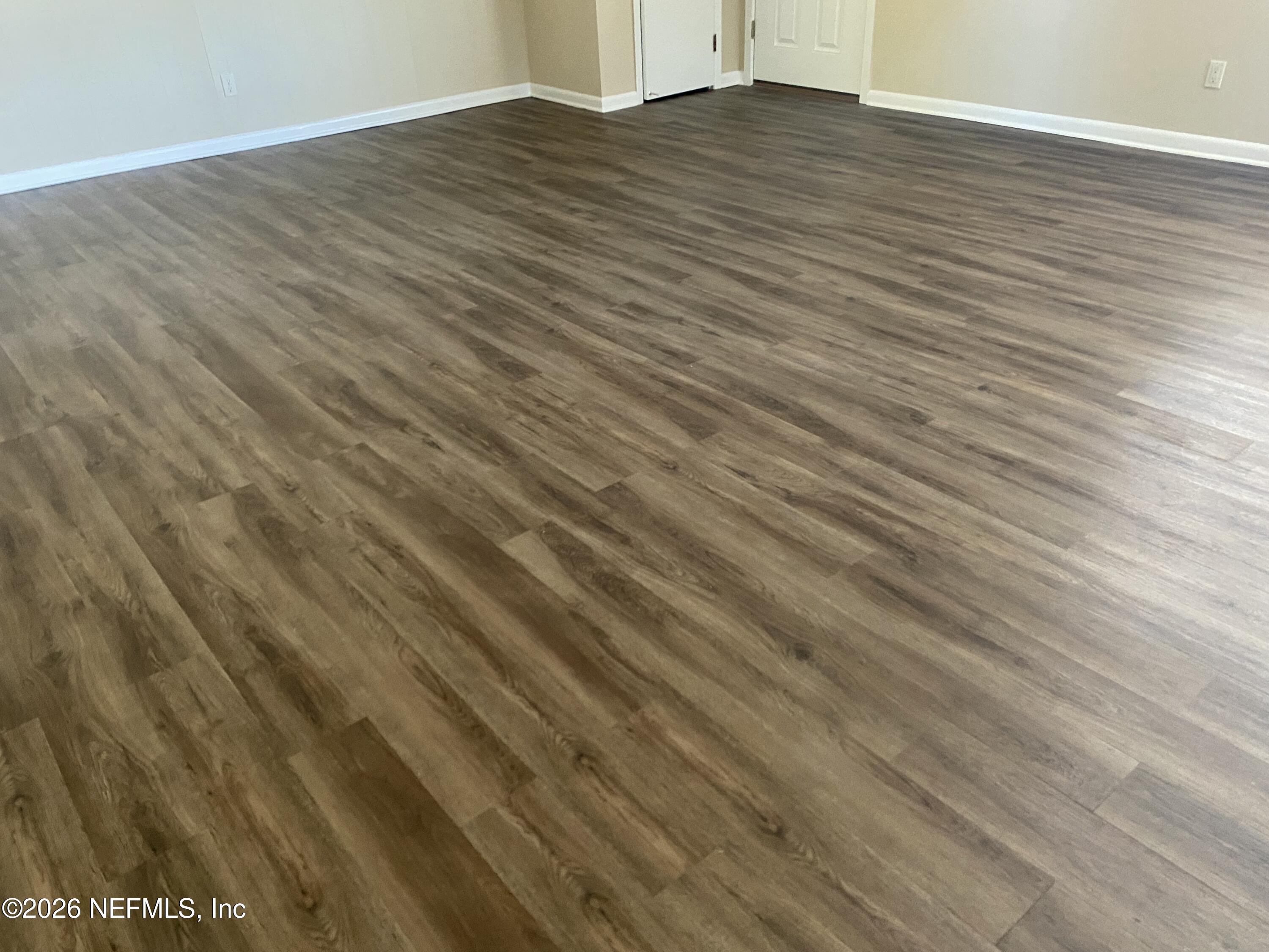 104 St Elmo Road Green Cove Springs, FL 32043 - Photo 19 of 24 a view of an empty room with wooden floor