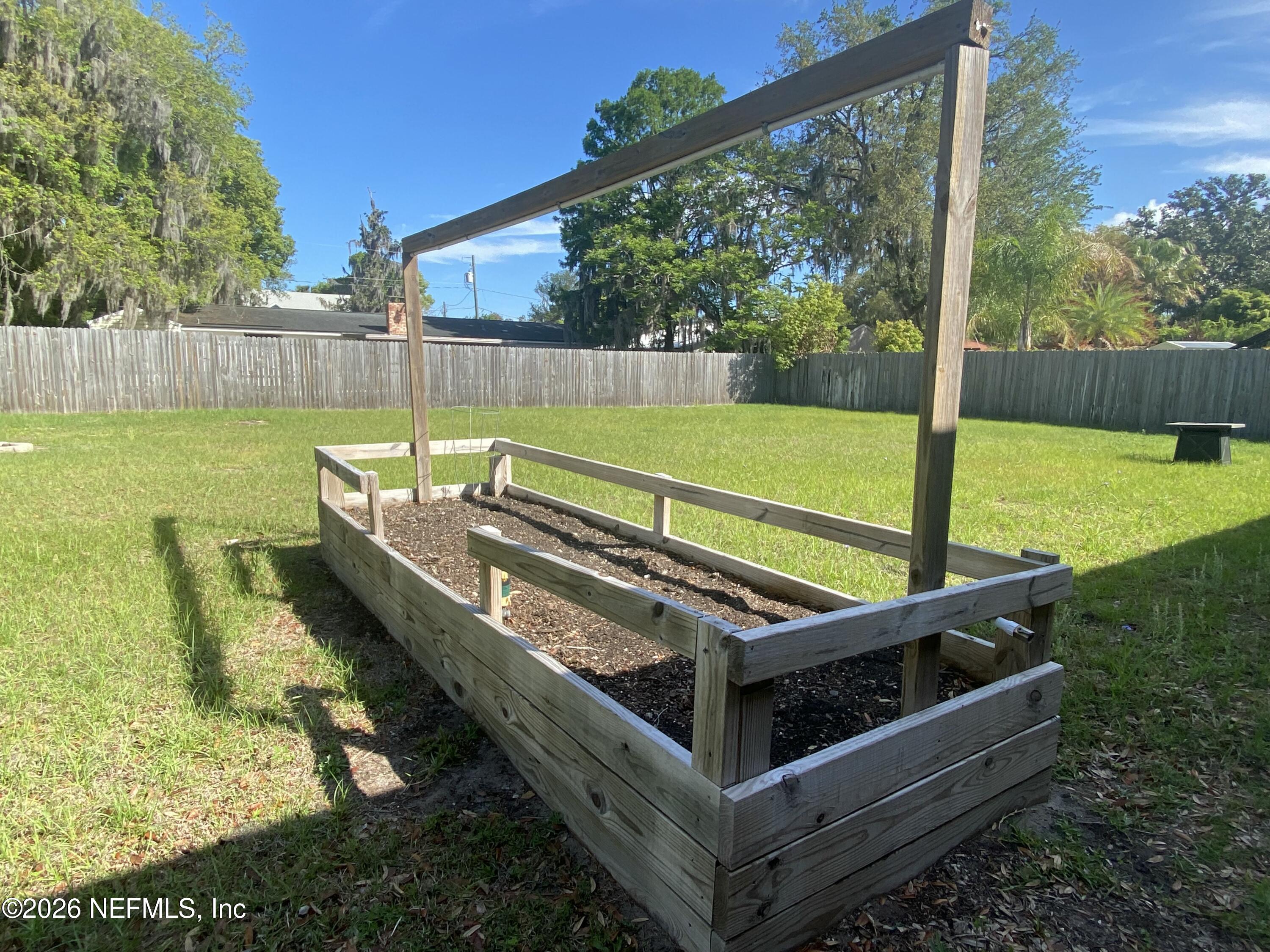 104 St Elmo Road Green Cove Springs, FL 32043 - Photo 22 of 24 a view of a two chairs in the garden