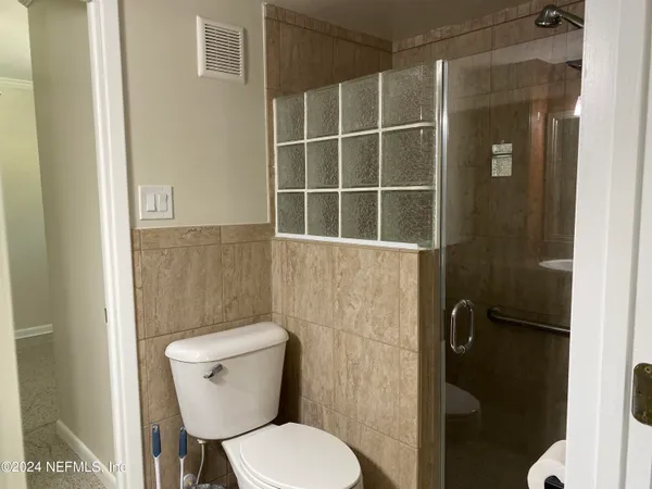 a white toilet sitting next to a bathroom sink