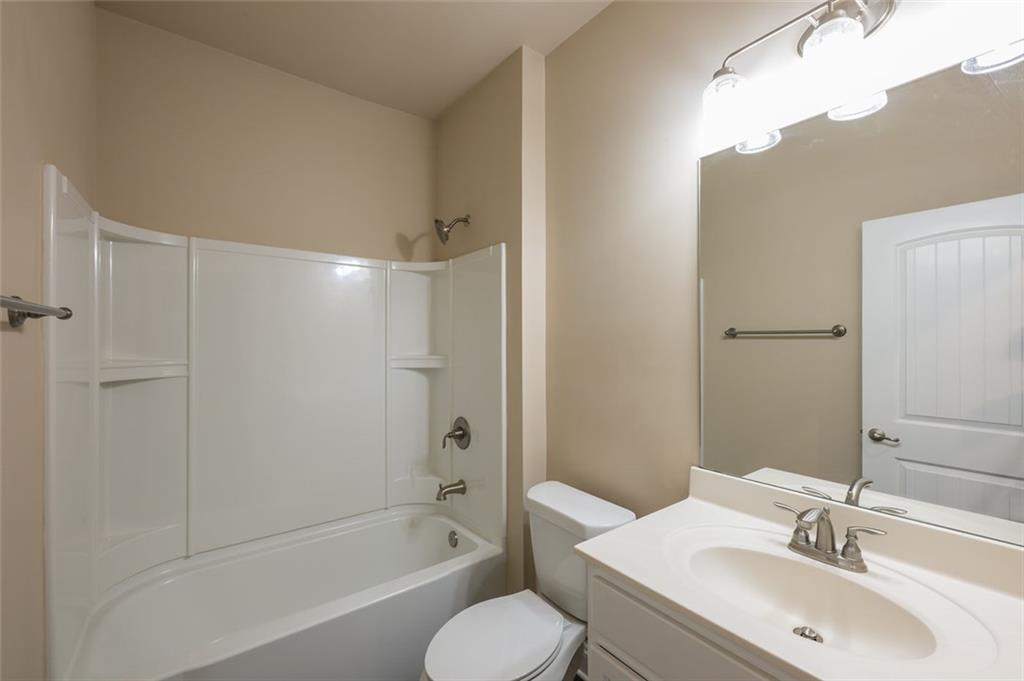 12172 Flannery Lane Hampton, GA 30228 - Photo 16 of 31 a bathroom with a sink toilet and shower