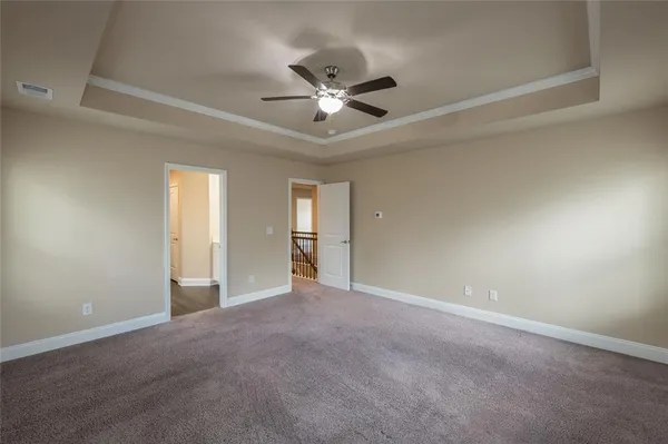a view of an empty room with a ceiling fan