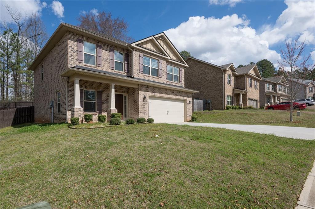 12172 Flannery Lane Hampton, GA 30228 - Photo 2 of 31 a view of a big house with a big yard and large trees