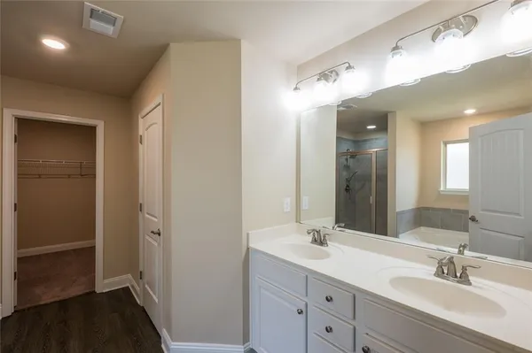 a bathroom with a double vanity sink and a mirror