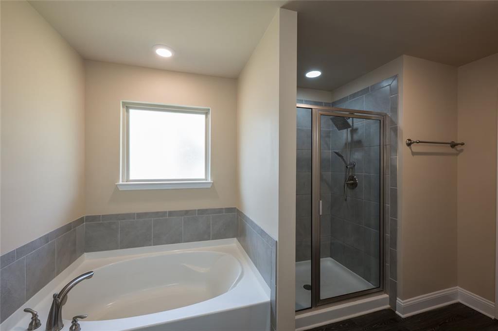 12172 Flannery Lane Hampton, GA 30228 - Photo 22 of 31 a bathroom with a bathtub and shower
