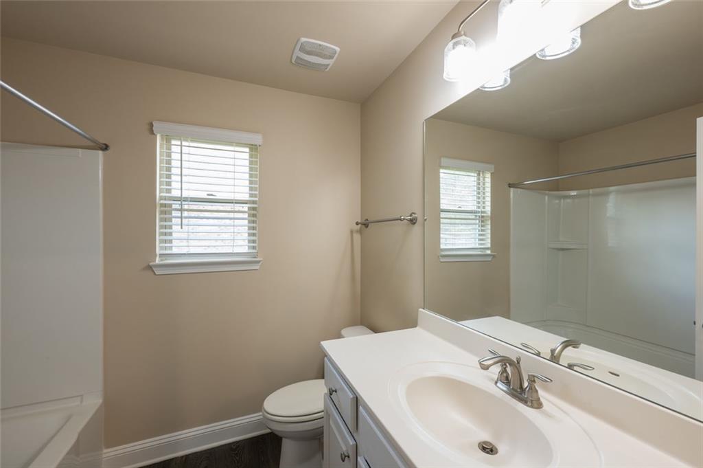 12172 Flannery Lane Hampton, GA 30228 - Photo 23 of 31 a bathroom with a sink toilet and vanity