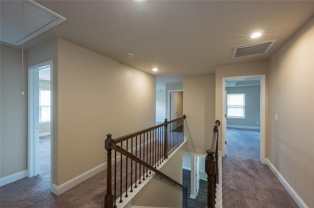 12172 Flannery Lane Hampton, GA 30228 - Photo 24 of 31 a view of a hallway with wooden floor and staircase