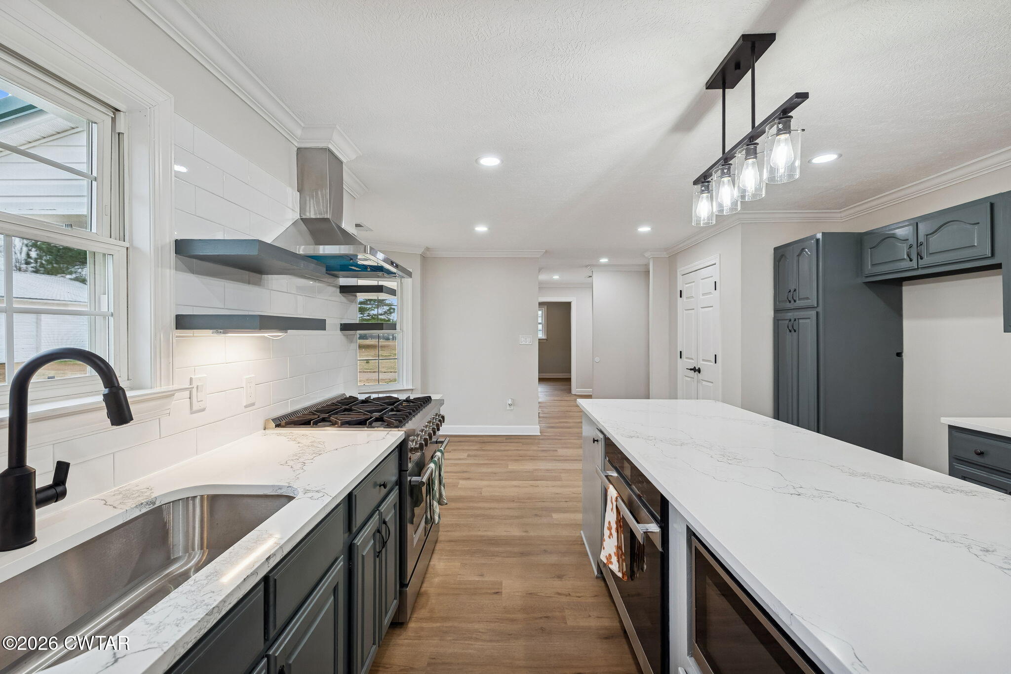 123 Walnut Hill Road Bells, TN 38006 - Photo 20 of 61 a kitchen with kitchen island stainless steel appliances a sink a counter top space a stove and a refrigerator
