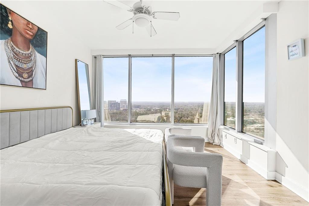 3338 Peachtree Road Northeast, Unit 3302 Atlanta, GA 30326 - Photo 13 of 42 a large bedroom with a large window and a bed