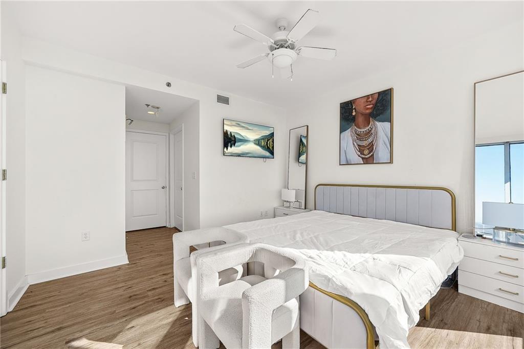 3338 Peachtree Road Northeast, Unit 3302 Atlanta, GA 30326 - Photo 14 of 42 a bedroom with a bed and a chandelier