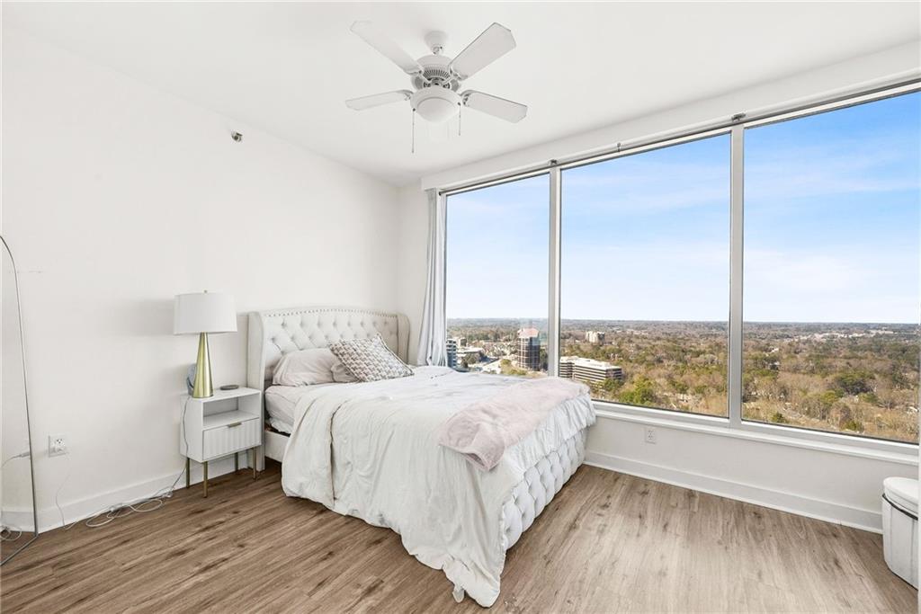 3338 Peachtree Road Northeast, Unit 3302 Atlanta, GA 30326 - Photo 16 of 42 a bedroom with a large bed and a large window with outer view