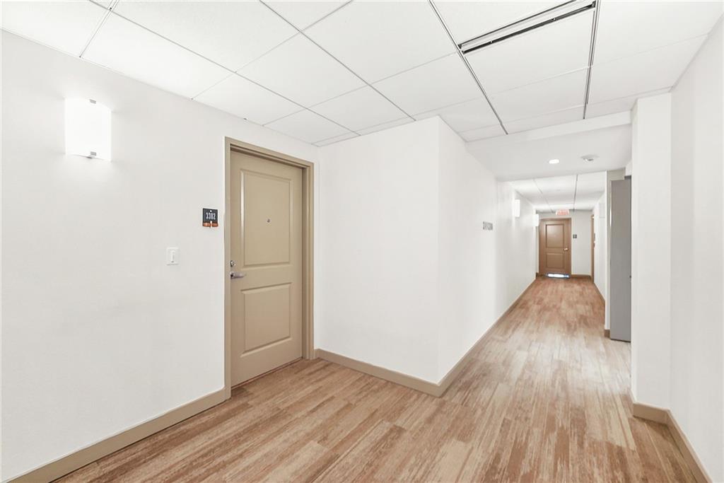 3338 Peachtree Road Northeast, Unit 3302 Atlanta, GA 30326 - Photo 19 of 42 a view of a hallway with wooden floor