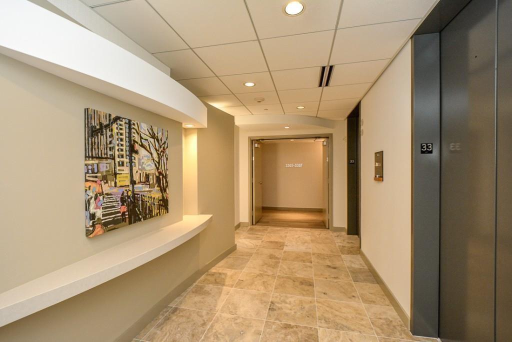 3338 Peachtree Road Northeast, Unit 3302 Atlanta, GA 30326 - Photo 34 of 42 a view of a hallway with wooden floor and a bathroom