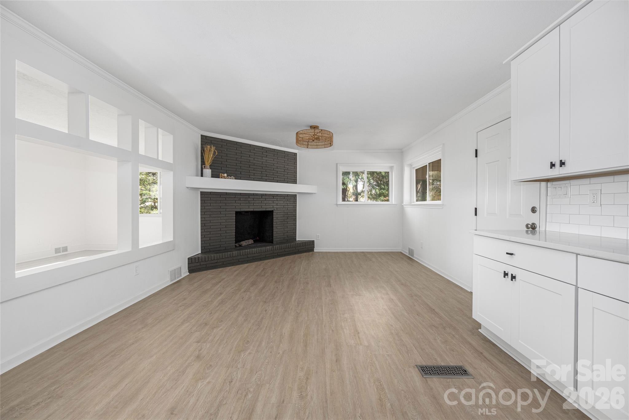 9424 Pembroke Road Huntersville, NC 28078 - Photo 14 of 39 a view of empty room with wooden floor and fireplace