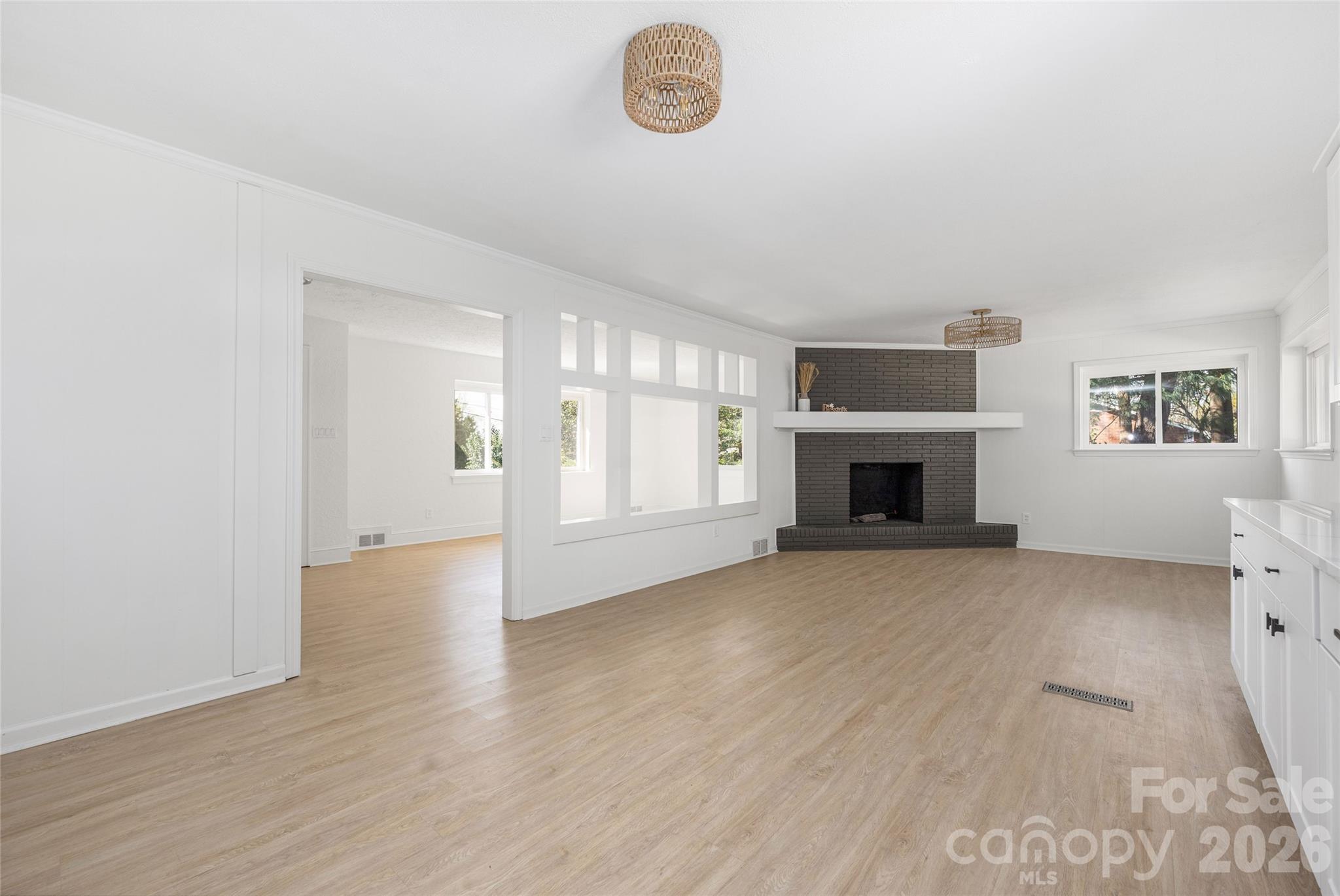 9424 Pembroke Road Huntersville, NC 28078 - Photo 15 of 39 an empty room with windows and fireplace