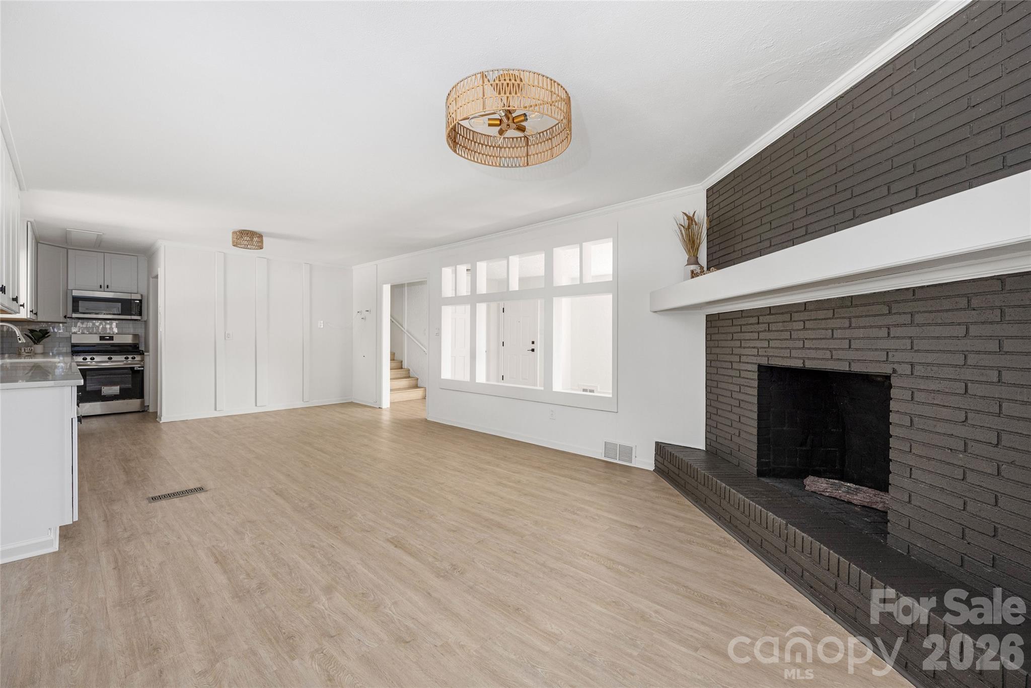 9424 Pembroke Road Huntersville, NC 28078 - Photo 16 of 39 a view of an empty room with a fireplace and a window
