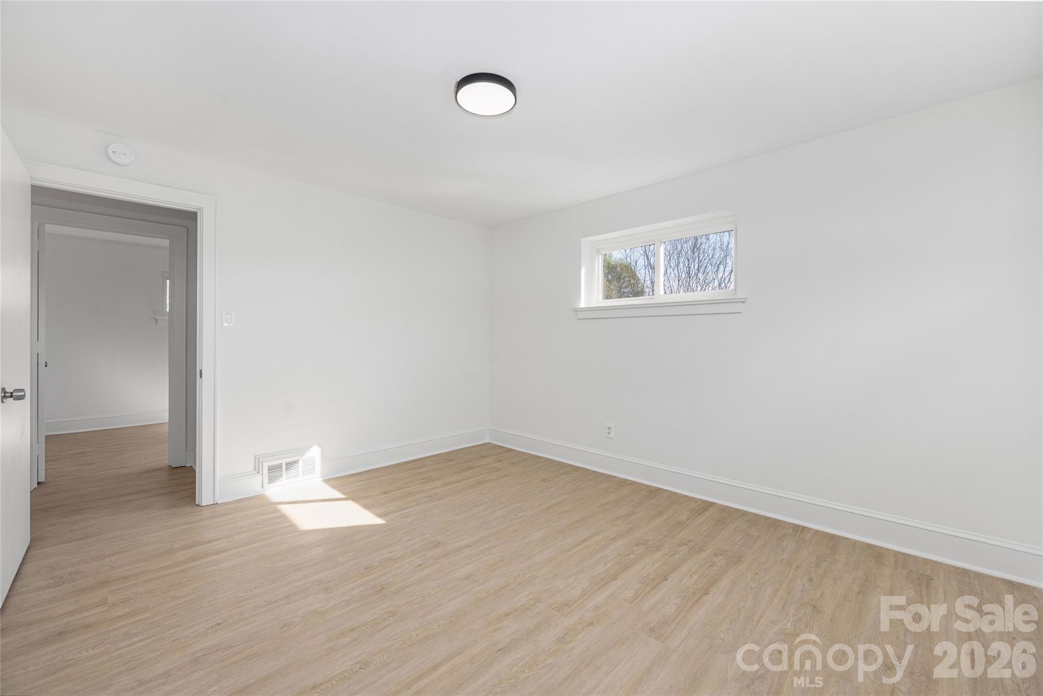 9424 Pembroke Road Huntersville, NC 28078 - Photo 18 of 39 an empty room with wooden floor and windows
