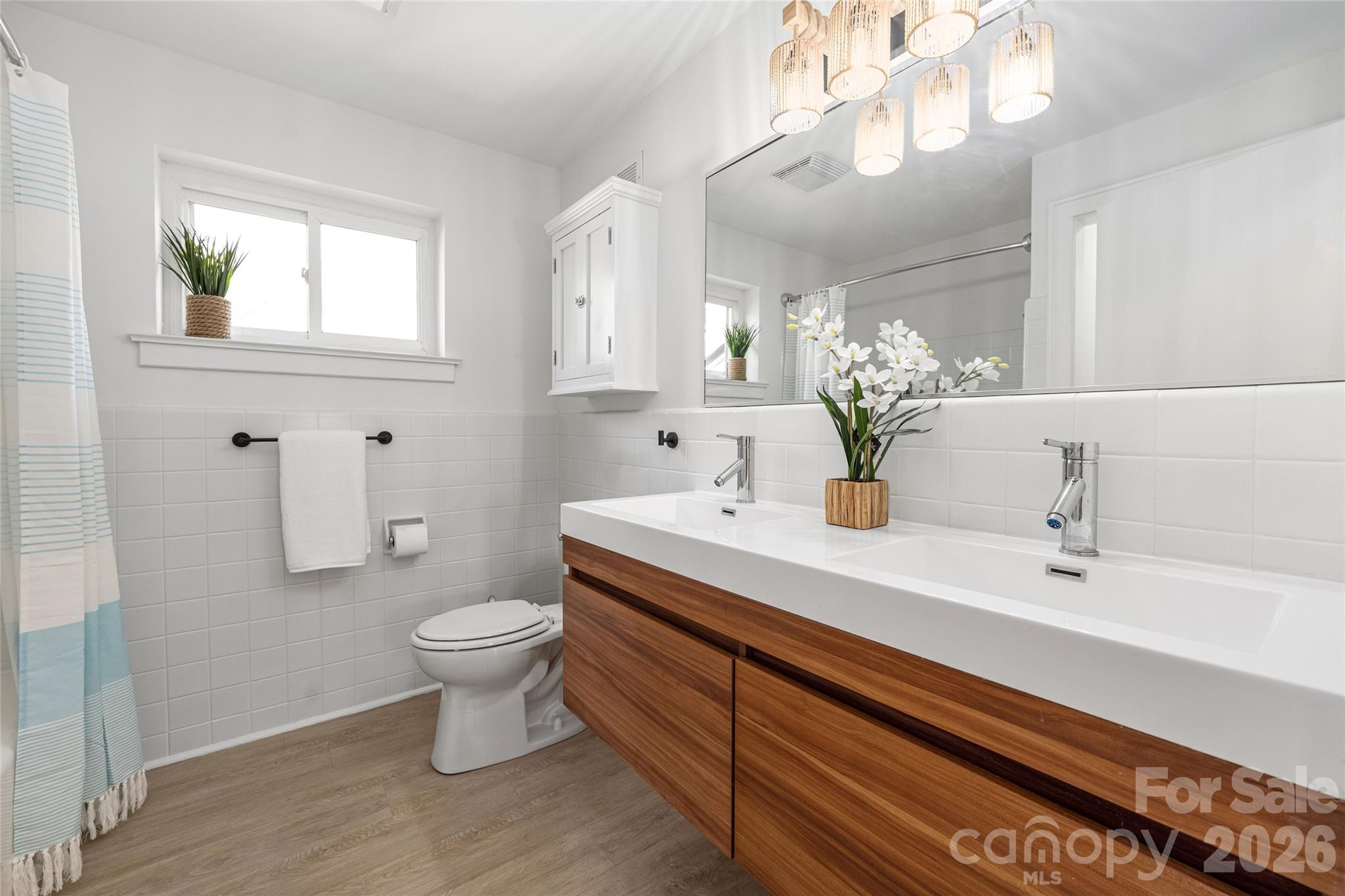 9424 Pembroke Road Huntersville, NC 28078 - Photo 22 of 39 a bathroom with a sink a toilet and mirror