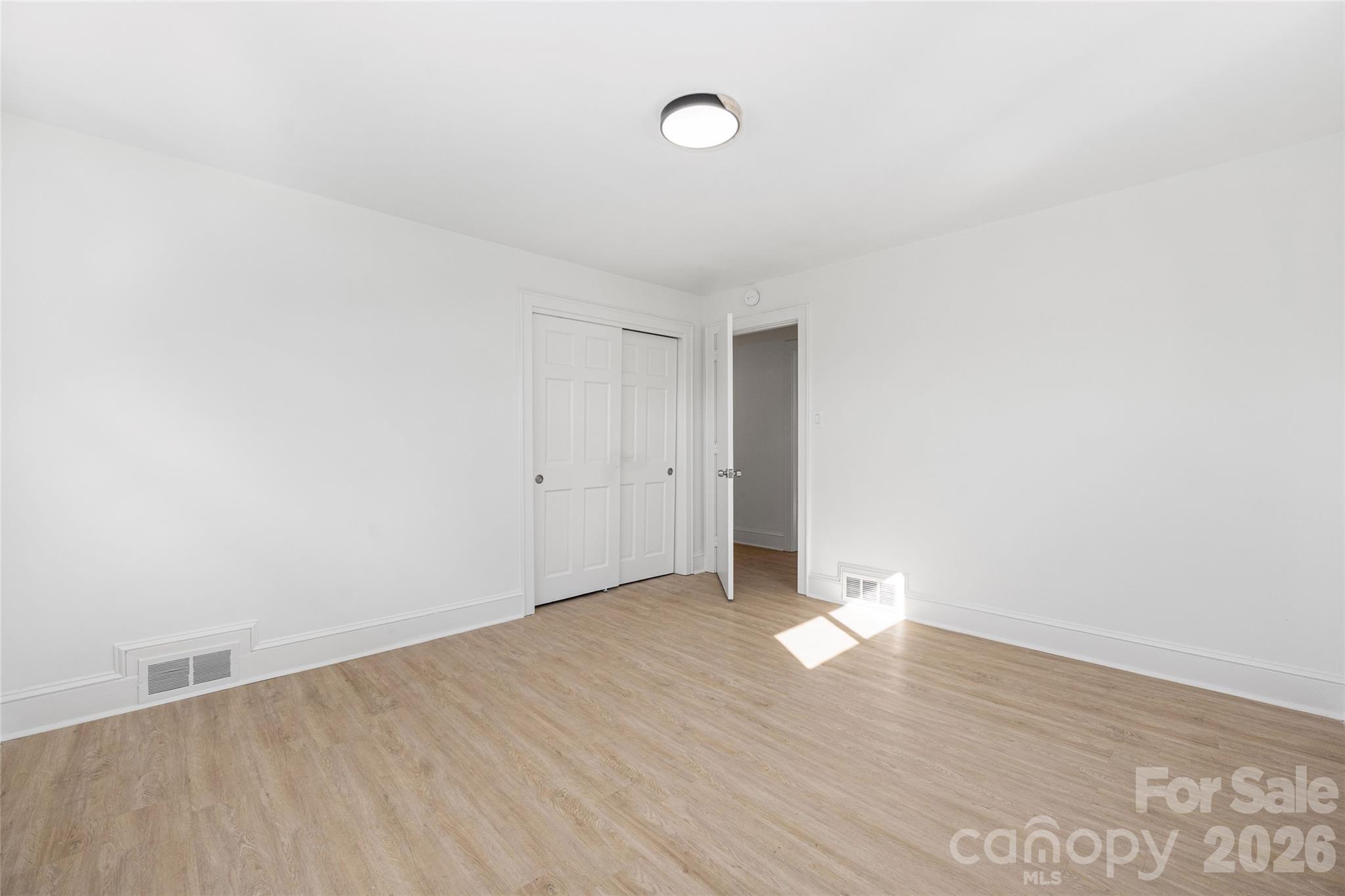 9424 Pembroke Road Huntersville, NC 28078 - Photo 25 of 39 a view of an empty room with wooden floor