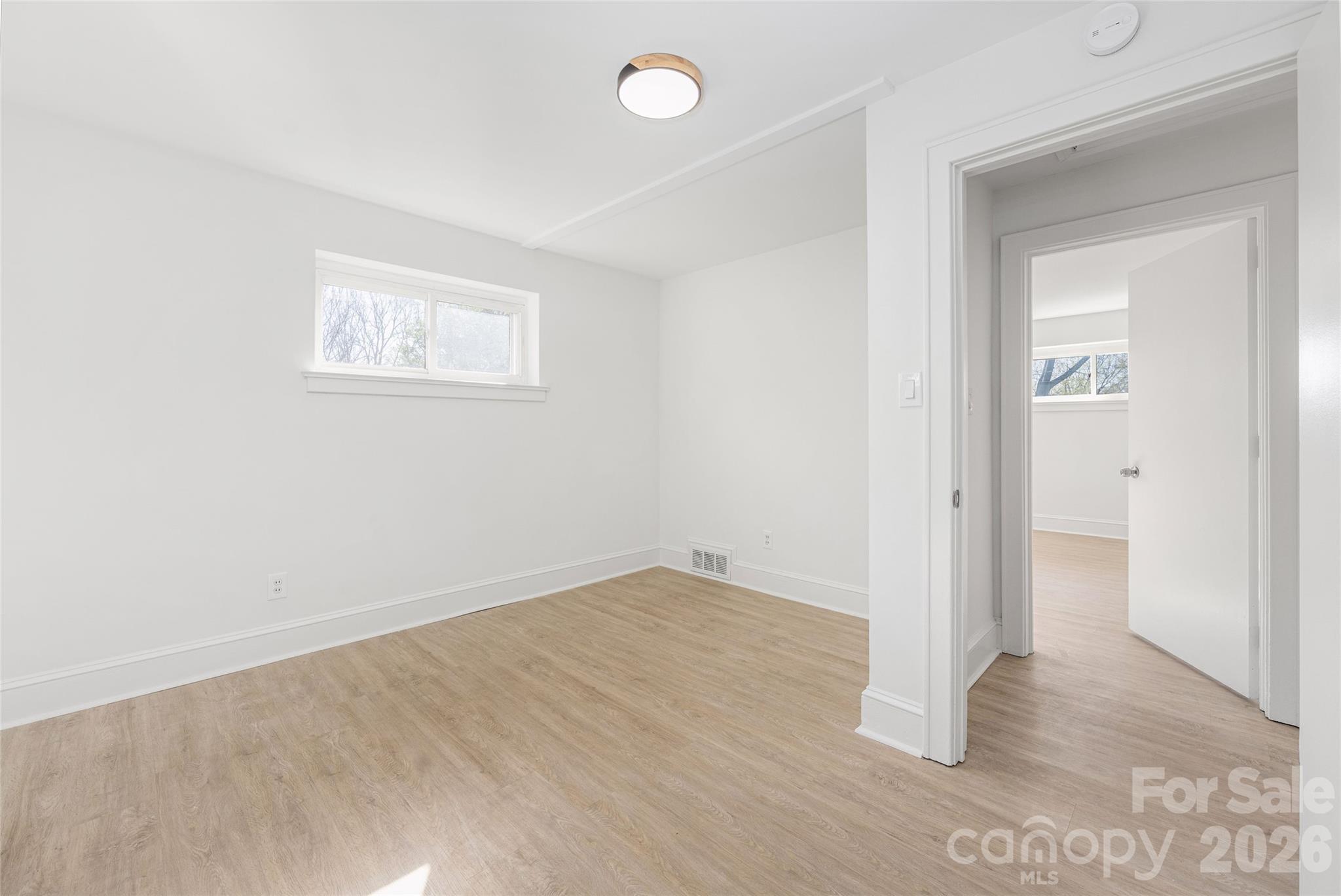 9424 Pembroke Road Huntersville, NC 28078 - Photo 26 of 39 an empty room with wooden floor and windows