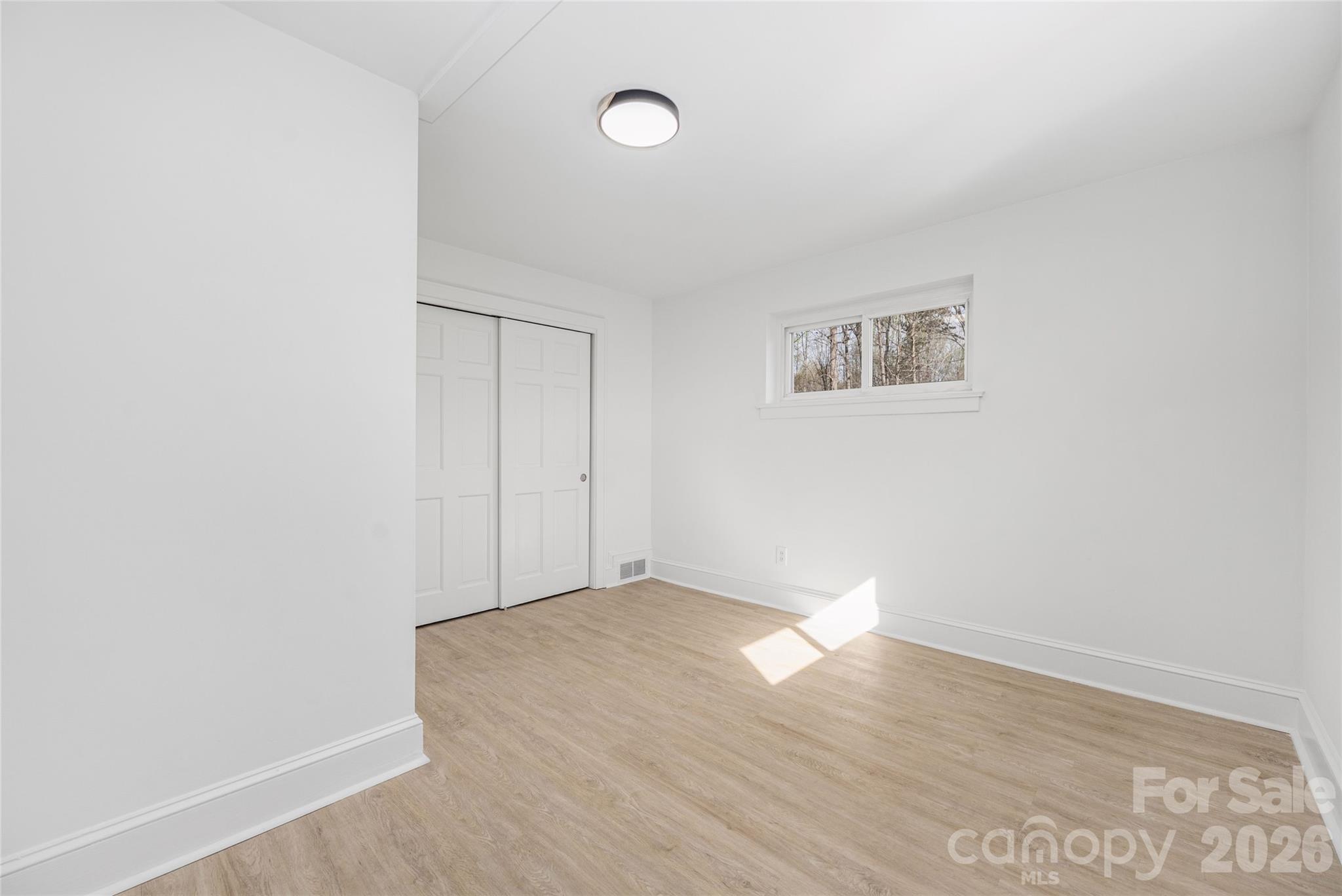 9424 Pembroke Road Huntersville, NC 28078 - Photo 28 of 39 a view of an empty room with wooden floor