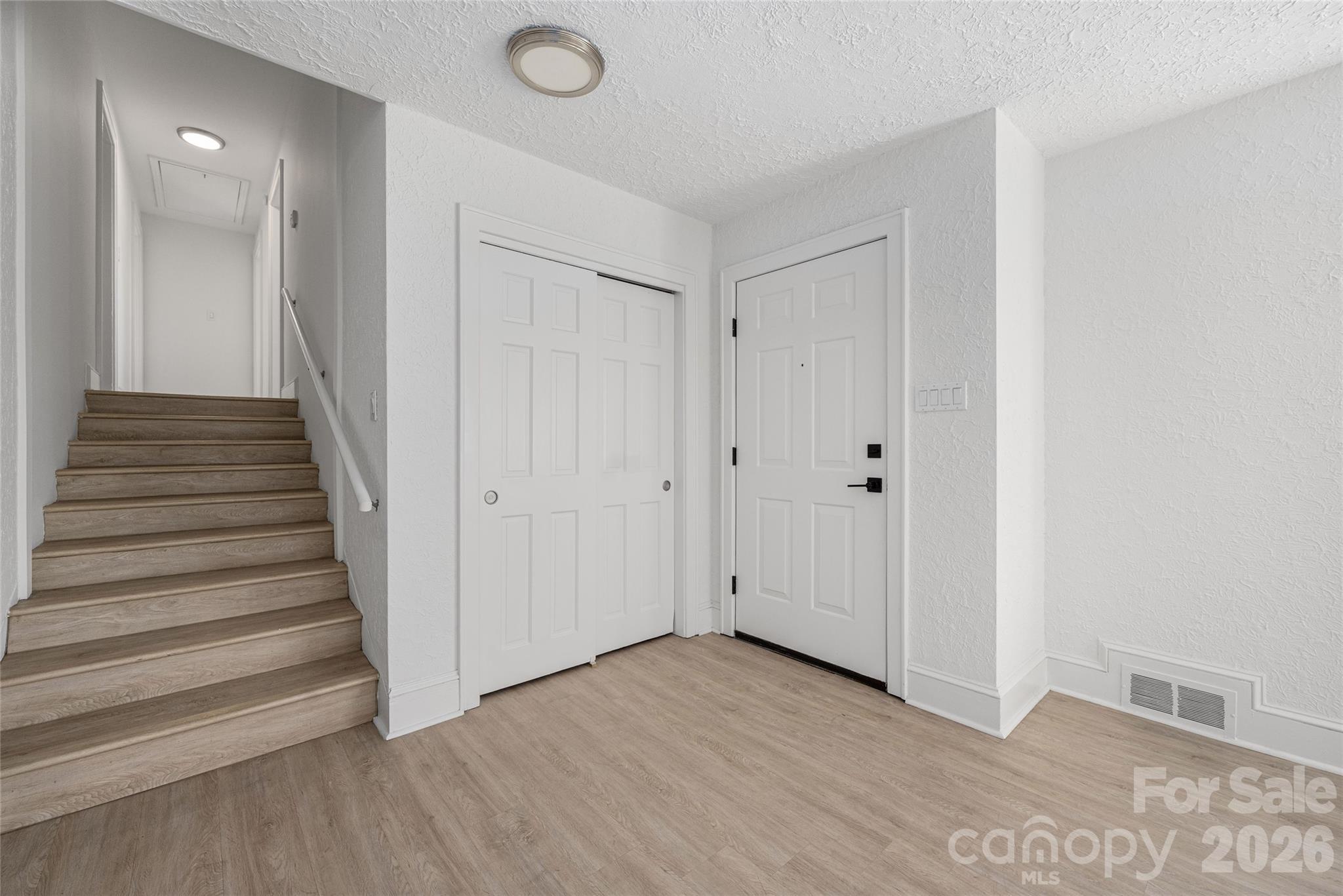 9424 Pembroke Road Huntersville, NC 28078 - Photo 6 of 39 a view of a hallway with wooden floor and entryway