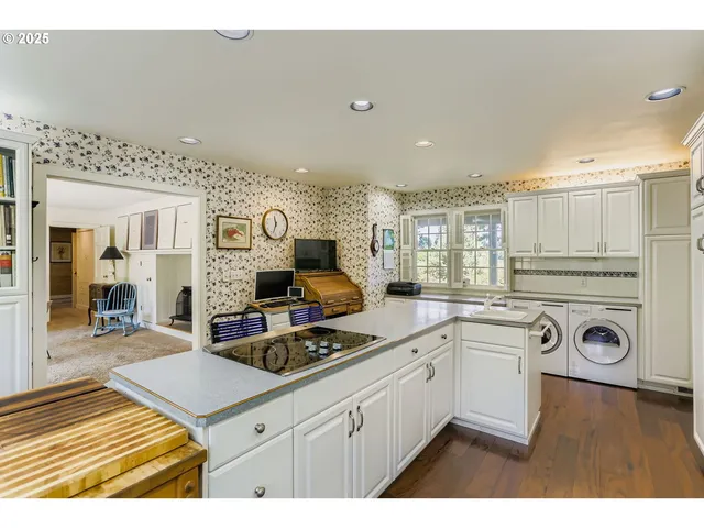 a kitchen with cabinets a sink and appliances