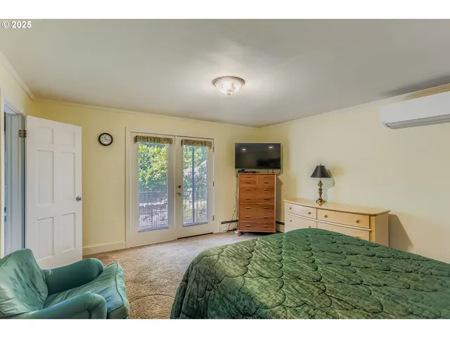 a bedroom with furniture and a window
