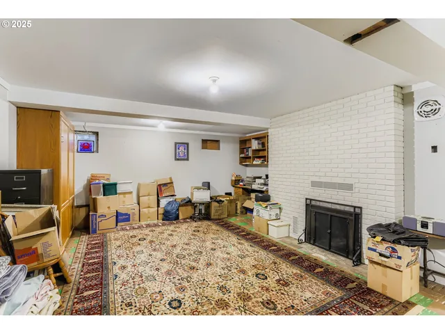 a bedroom with furniture a fireplace and a flat screen tv