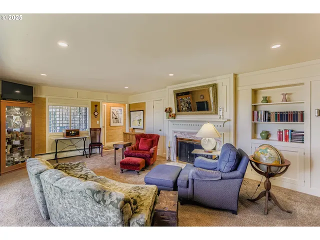 a living room with furniture a fireplace and a flat screen tv