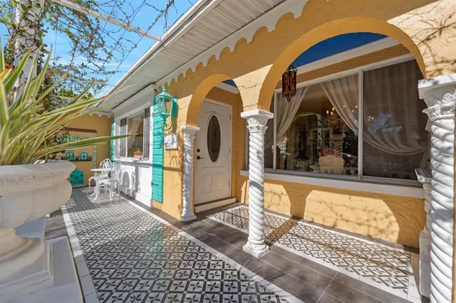 a living room with fireplace furniture and a chandelier